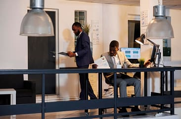 Executive-manager-sitting-at-desk-in-startup-office Office Space