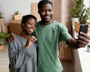 Front-view-of-smiley-couple-taking-selfie-in-their-new-home Couple Renting Home